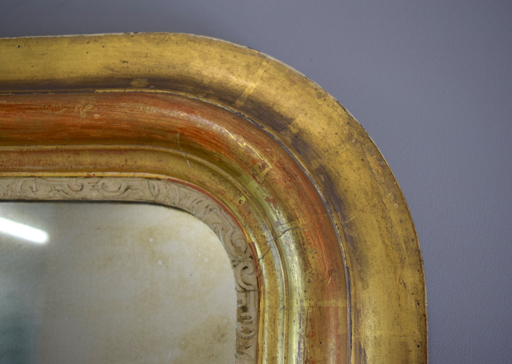 Late 19th Century French Gilt Mirror with Warm Red Bole Under