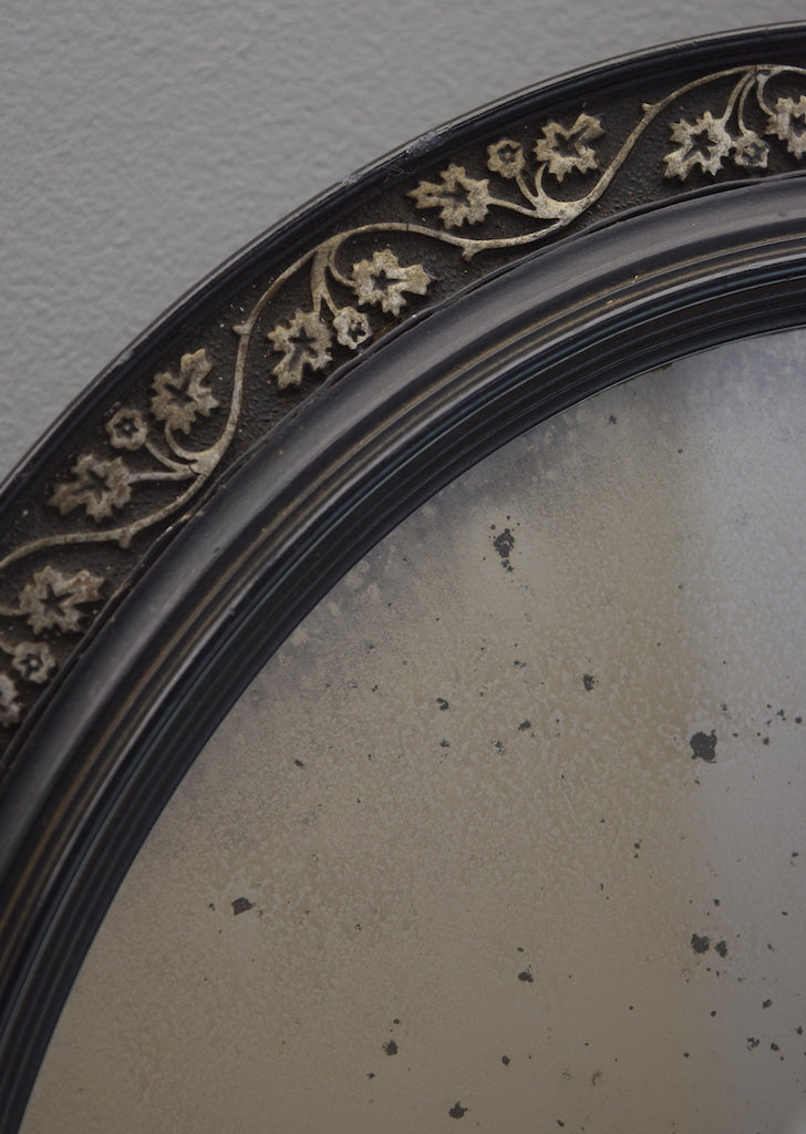 Pair of Ebonised Oval Mirrors
