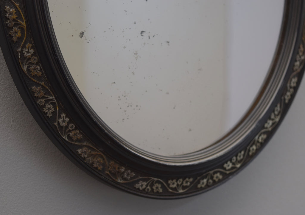 Pair of Ebonised Oval Mirrors