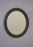Late 19th Century French Ebonised Oval Mirror with Gold Detail