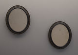 Pair of Ebonised Oval Mirrors